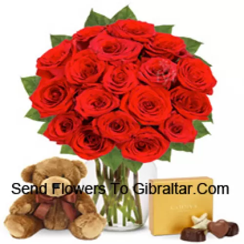 11 Red Roses With Some Ferns In A Glass Vase Accompanied With An Imported Box Of Chocolates And A Cute 12 Inches Tall Brown Teddy Bear