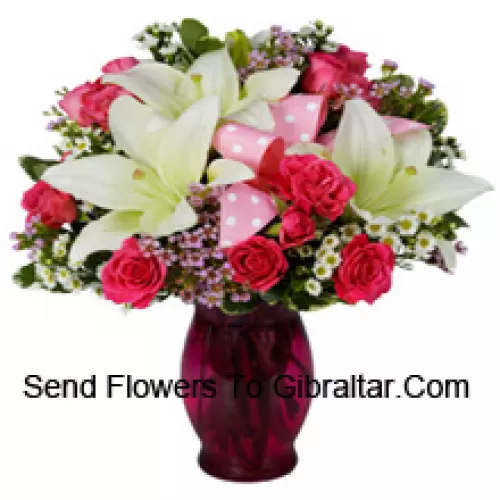 Pink Roses And White Lilies With Seasonal Fillers In A Glass Vase