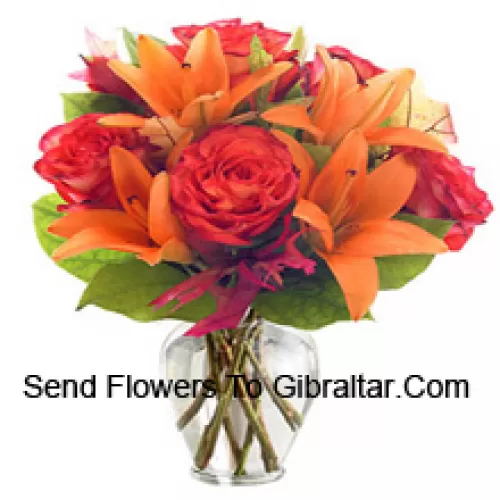 Orange Lilies And Orange Roses With Seasonal Fillers Arranged Beautifully In A Glass Vase