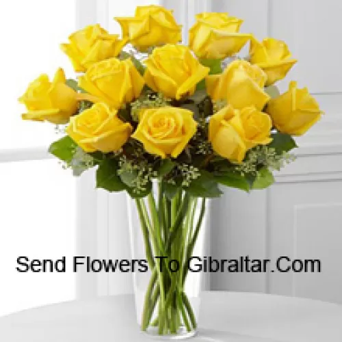 11 Yellow Roses With Some Ferns In A Glass Vase