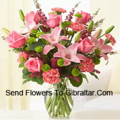 Pink Roses, Pink Carnations And Pink Lilies With Assorted Ferns And Fillers In A Glass Vase