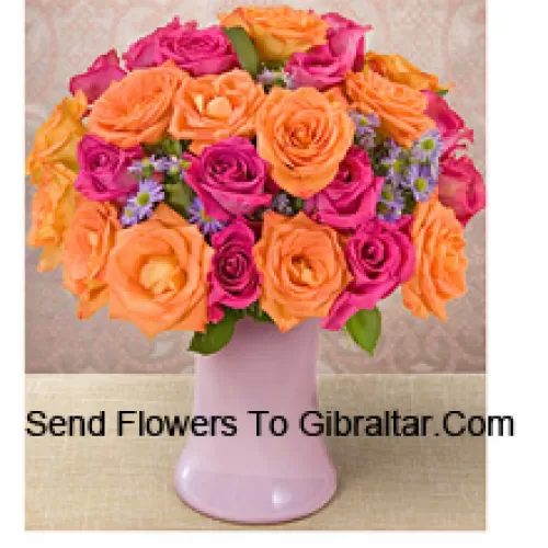 15 Pink And 10 Orange Roses With Seasonal Fillers In A Glass Vase