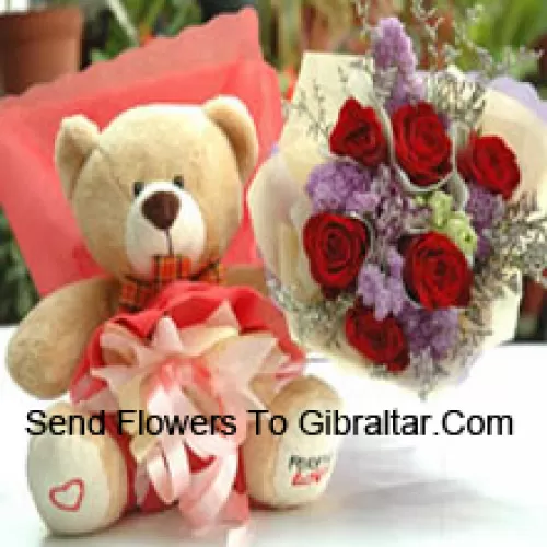 Bouquet de 7 roses rouges et un mignon ours en peluche de taille moyenne