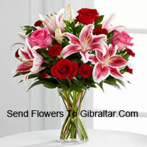 Red And Pink Roses With Pink Lilies And Seasonal Fillers In A Glass Vase